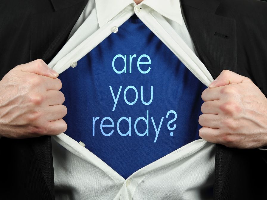 Business man opening shirt to reveal Are You Ready words